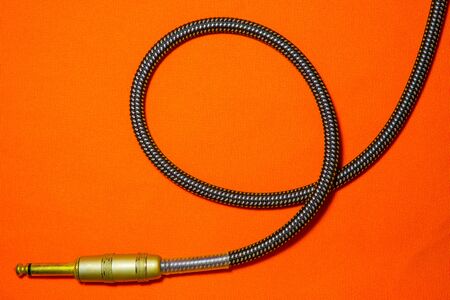 music concept guitar cable audio orange background