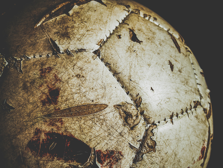 dirty football with traces of bloodの写真素材