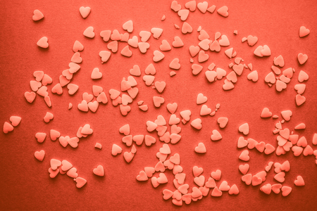 Hearts for Valentine's Day flat background in living coral pantone colorの写真素材