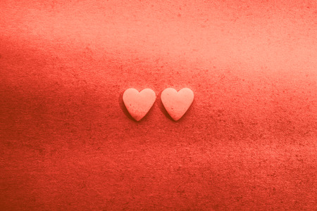 Hearts for Valentine's Day flat background in living coral pantone colorの写真素材