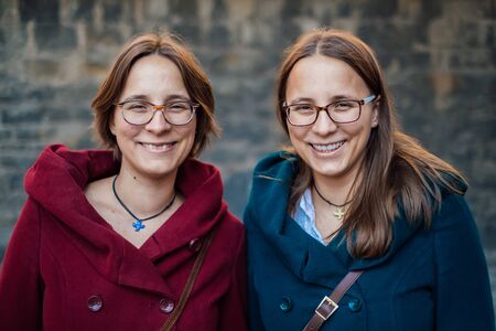 twin sisters having fun in the cityの写真素材