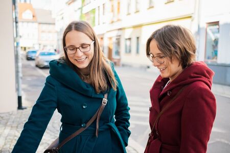 twin sisters having fun in the cityの写真素材
