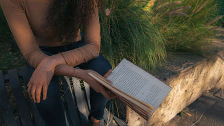 hands of a woman holding a bookの写真素材