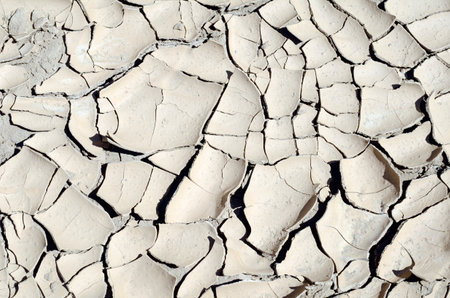 Cracks in the mud of a reservoir due to droughtの写真素材