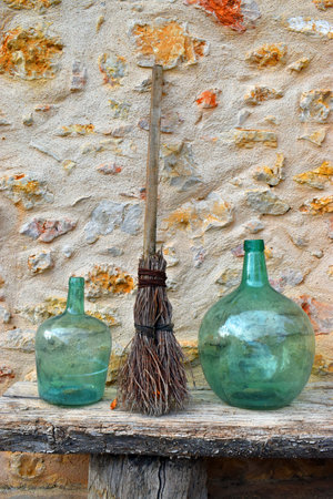 Rustic decoration with glass vases and a briar broomの写真素材