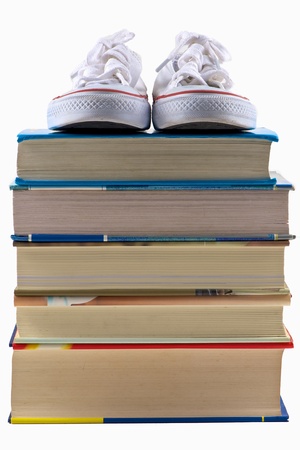 School shoe on stack of book on isolated white backgroundの写真素材