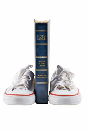 Bible and school shoe on isolated white backgroundの写真素材
