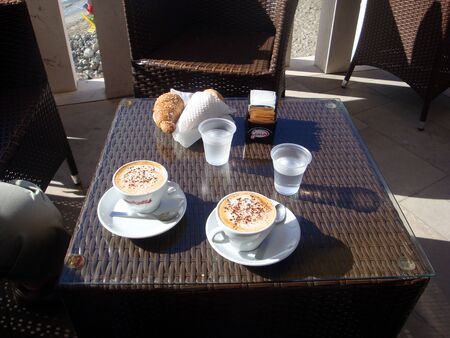 Otranto, Italy, Europe - July 11, 2016 breakfast by the sea with croissant and cappuccinoのeditorial素材
