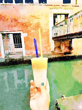 a hand with a glass of granita in the historic center of Veniceの写真素材