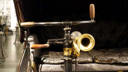 Turin, Italy - June 20, 2021: a view of the handlebar and pump horn of an antique car at the...