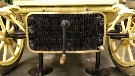 Turin, Italy - June 20, 2021: a view of a radiator and a crank of an antique car at the Automobile...