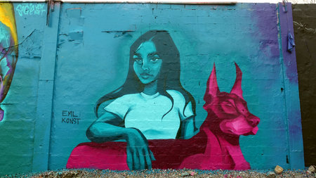 Stockholm, Snosatra, Sweden. May 12 2024. Spring beast. Graffiti exhibition on the outskirts of the city. Girl and dog.のeditorial素材