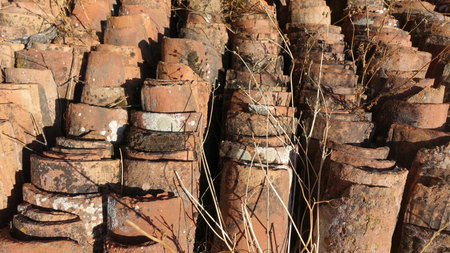 Hundreds of antique roof tiles piled in a row ready to be used for a new home.の写真素材