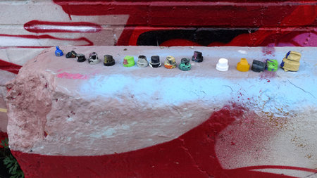 Collection of spray paint nozzles used in creating graffiti.