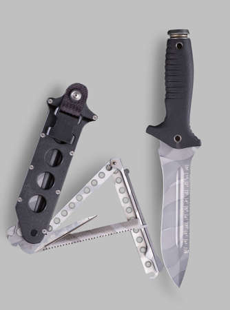 Combat survival knife with sheath on a gray backgroundの写真素材