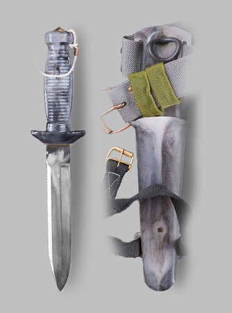 Underwater Combat knife with sheath on a gray backgroundの写真素材
