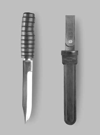 Underwater knife with sheath on a gray background with shadowの写真素材