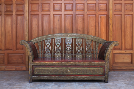 Vintage long aram chair made from hard wood on the floorの写真素材