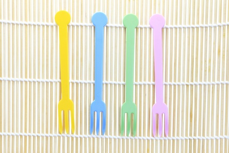 Plastic fork on bamboo backgroundの写真素材