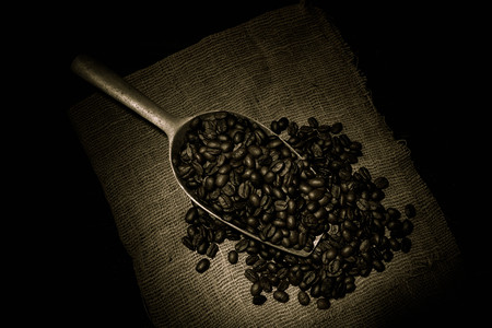 roasted coffee bean purifying from spoon in still life style