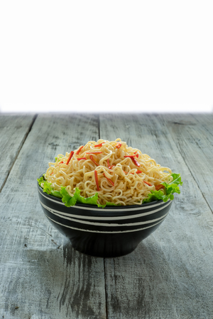 Instant noodle in the bowl on wooden backgroundの写真素材