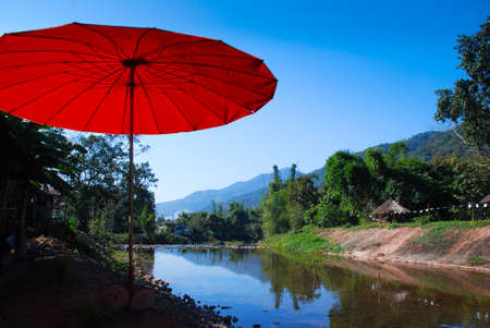 Red umbrella and clearly lake in resortの写真素材