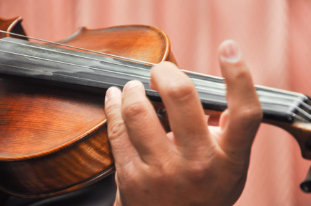 Close up photo of man playing violin, Select focus with shallow depth of fieldの写真素材