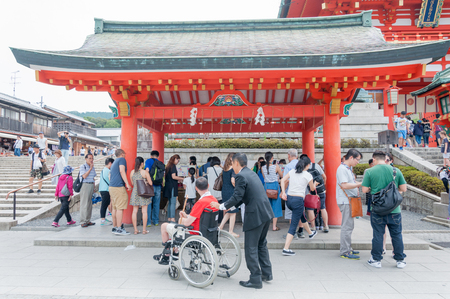 KYOTO, JAPAN - August 11, 2015: The tourist on the wheelchair get in wash hand section on tori gates at Fushimi Inari Shrine in Kyoto, Japanのeditorial素材