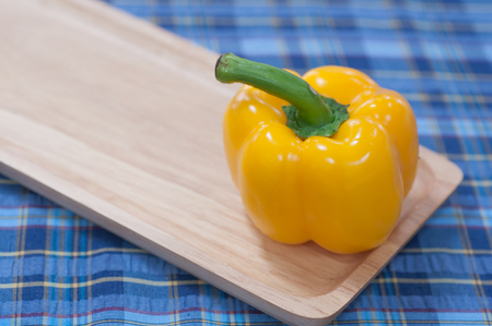 Sweet pepper on wood pan and fabric pattern backgroundの写真素材