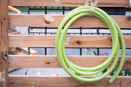 Rubber tube for watering plants in the gardenの写真素材