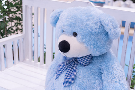 Big blue bear doll sit on the chairの写真素材