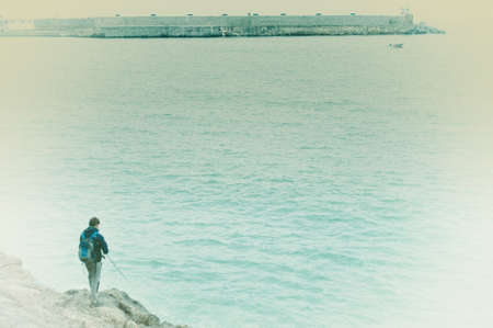 Man fishing in the rocksの写真素材