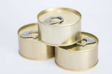 Tuna cans stacked on a white background