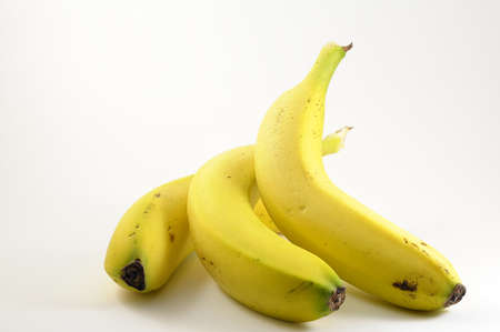 Three bananas on a white backgroundの写真素材
