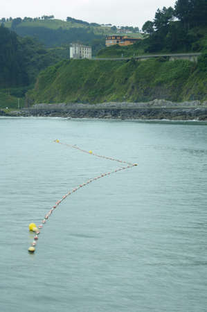 Fishing buoy abandoned in the middle of the bayの写真素材