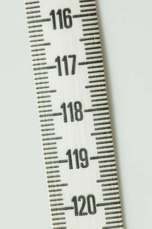 Close-up of a tape measure on a neutral background
