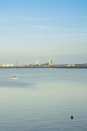 Fishing boat in the bay in the morningの写真素材