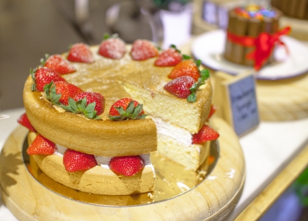 Sweet homemade cake with strawberry and whipped cream close up.