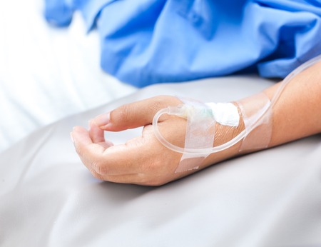 sick lady lying in hospital bedの写真素材