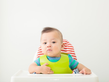 happy baby child sitting in chair