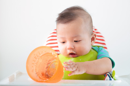 happy baby child sitting in chairの写真素材
