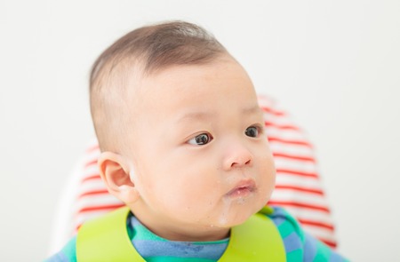 happy baby child sitting in chairの写真素材