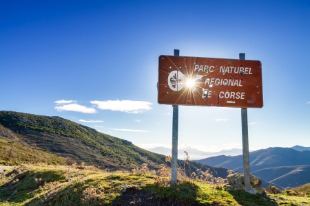 Parc Natural De Corse signpost riddled with hunter