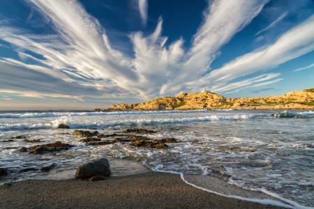 The lighthouse on the red rock in the town of Ile Rousse in the Balagne region of Corsicaの写真素材