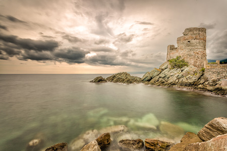 Genoese tower against a dramatic sky at Erbalunga on Cap Corse in northern Corsicaの写真素材