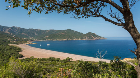 Galeria beach on the west coast of Corsica with boats moored in the blue Mediterranean seaの写真素材