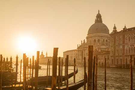 Gondolas at dawn on the Grand Canal in Venice in front of the Basilica di Santa Maria della Saluteの写真素材