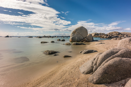 Deserted sandy beach and boulders on coast of Cavallo island near Corsica in France with blue Mediterranenan and blue skyの写真素材