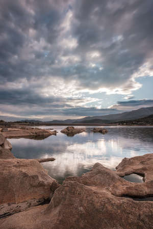 Wide angle image of dawn breaking over the Lac de Codole and distant mountains in the Balagne region of Corsicaの写真素材