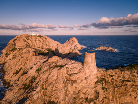 Aerial view of early morning sun on the lighthouse and Genoese tower at La Pietra in Ile Rousse in the Balagne region of Corsicaの写真素材
